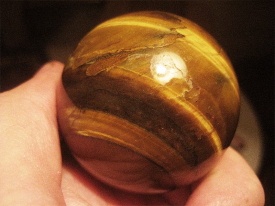 A Tiger Eye chatoyant gemstone which will be used for a trackball